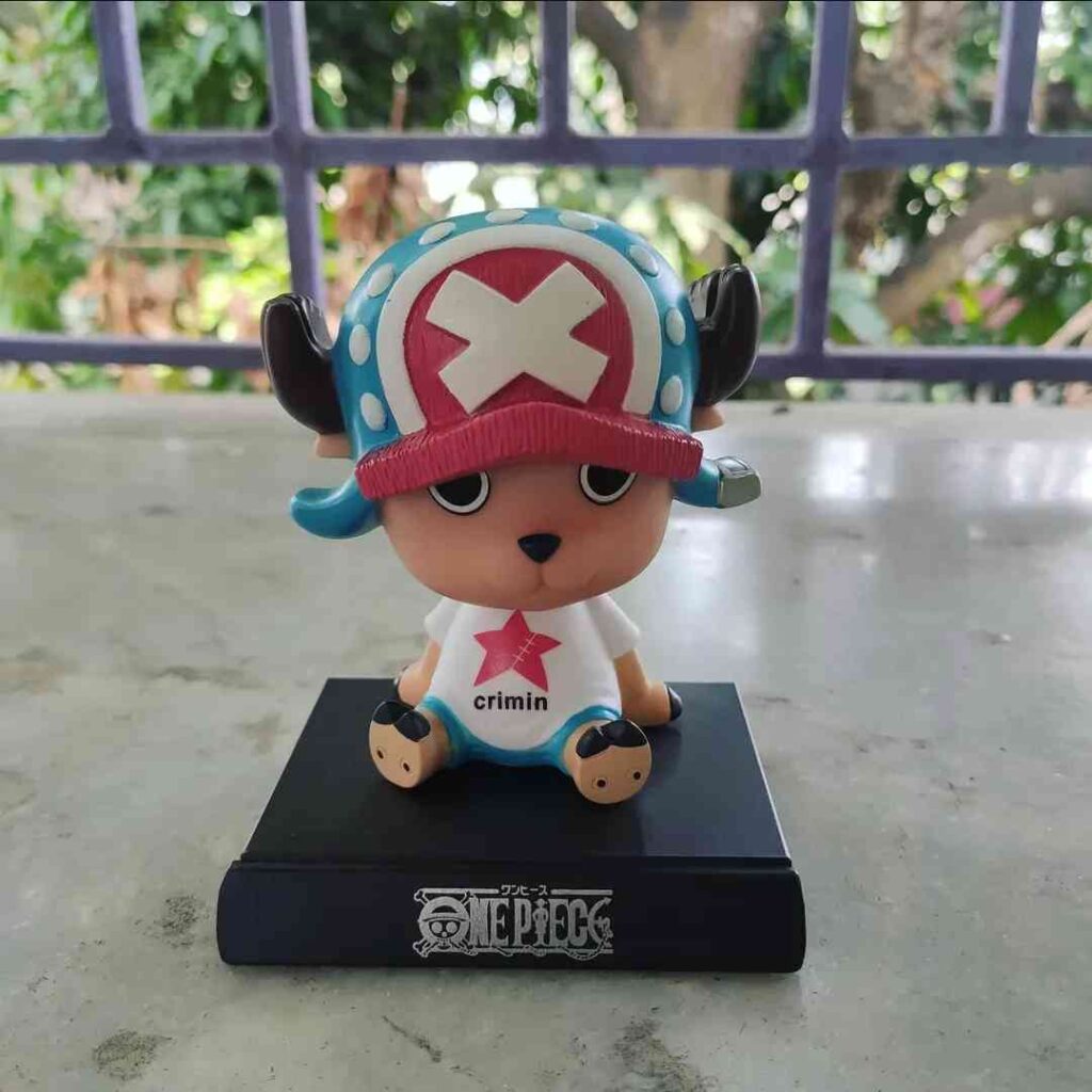 Tony Tony Chopper bobble head on student study desk in natural morning light